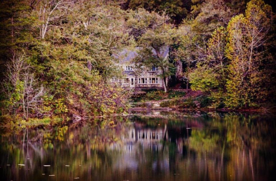 Rockford Grange Cottage reflected in the spring-fed lake